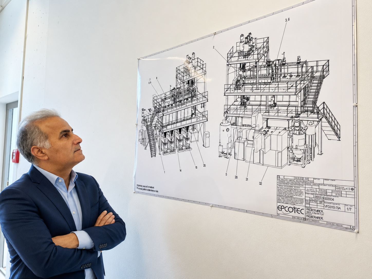 EPCOTEC project director Abi Fini reviewing an industrial fiber plant engineering drawing