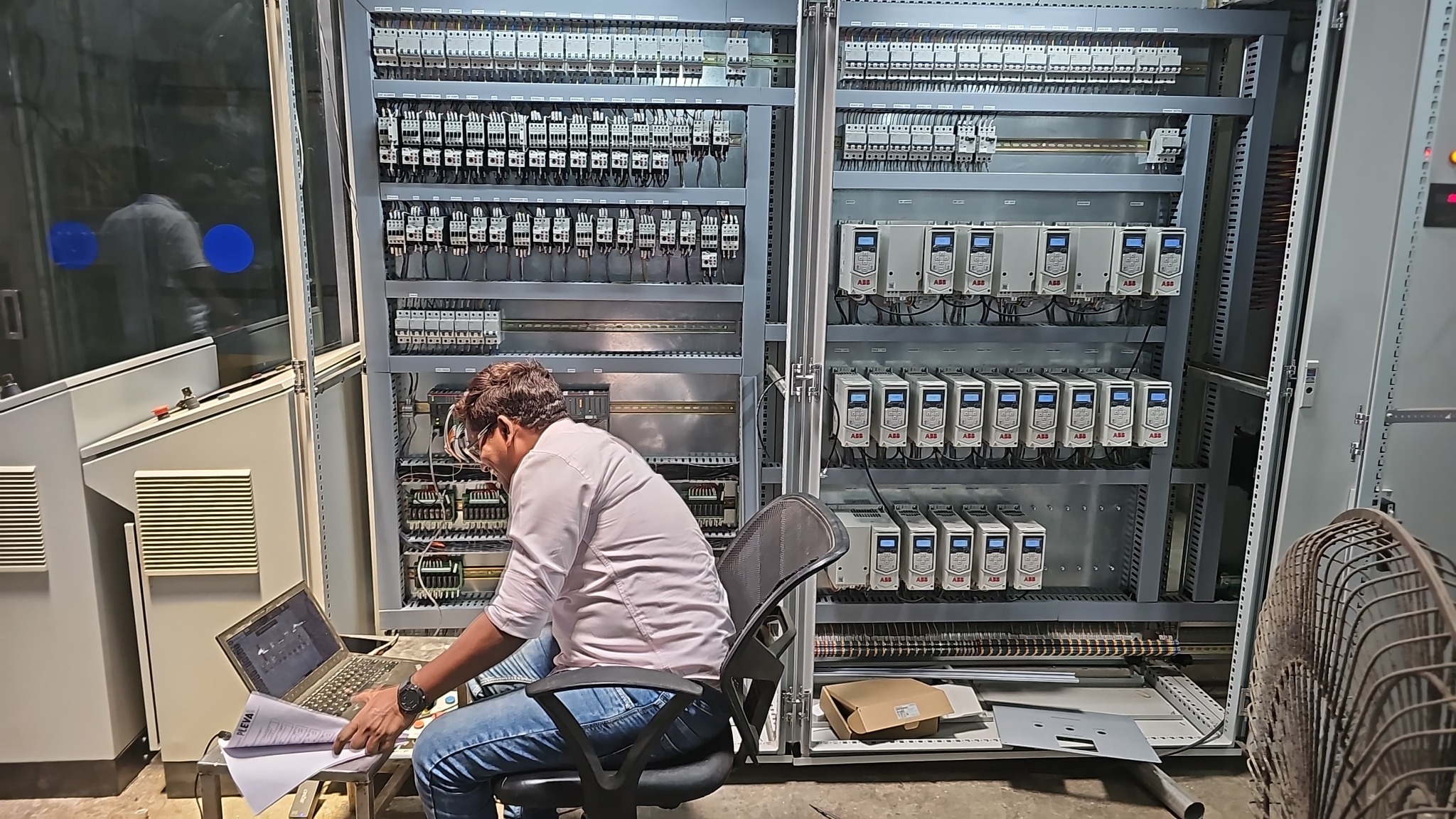 Automation engineer commissioning an industrial control cabinet